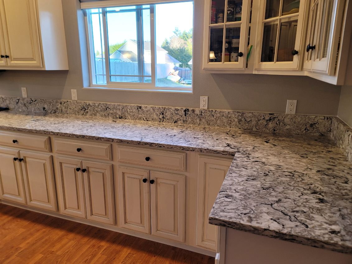 Bold black-and-white swirl granite countertop with glazed cabinetry