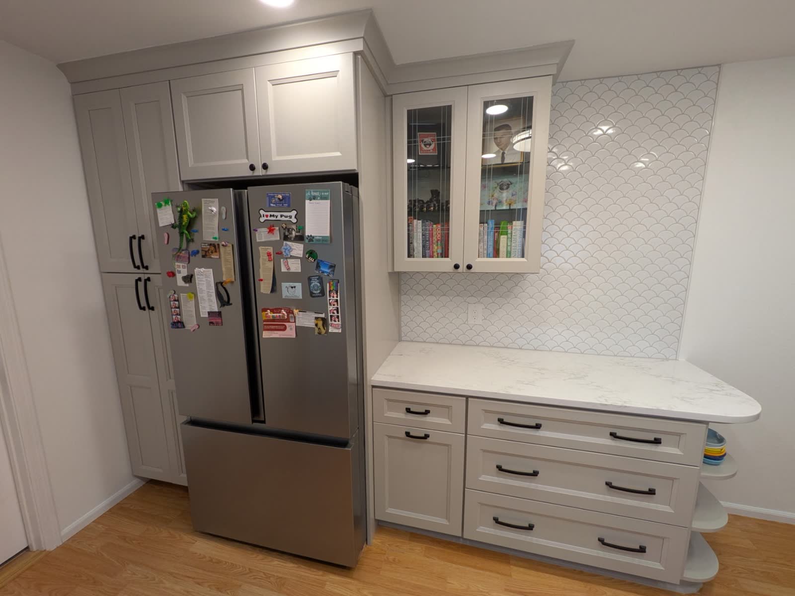 Custom pantry wall with marbled quartz counter and fish-scale tile backsplash