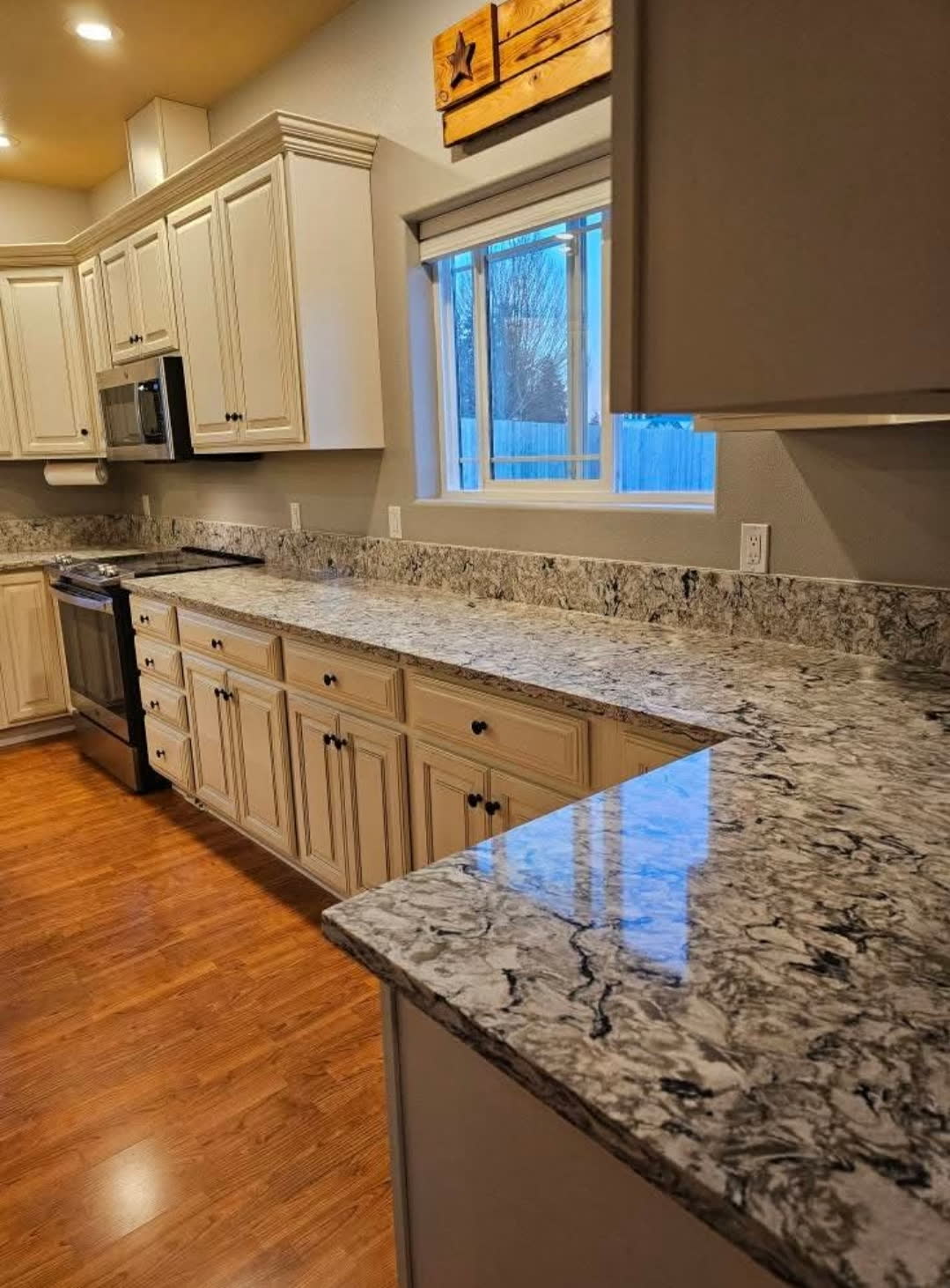 Cambria-style veined quartz countertops in a warm traditional kitchen
