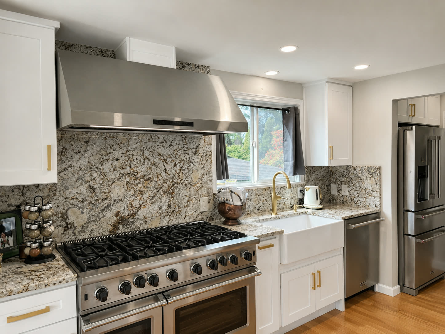 Luxury range wall with full-height dramatic stone backsplash and white cabinetry