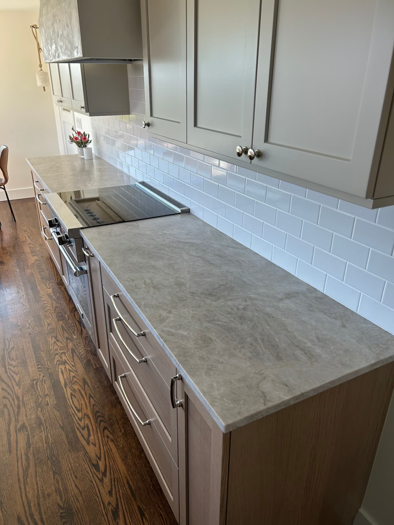 Wood grain — Modern-rustic wood-grain cabinets with a honed dark counter.