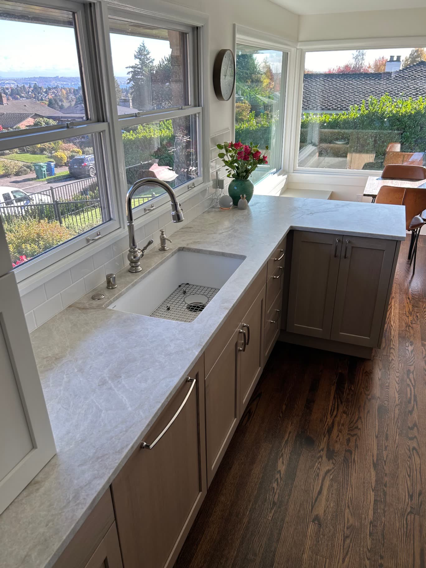 Sunlit kitchen sink with quartzite counters and city view windows