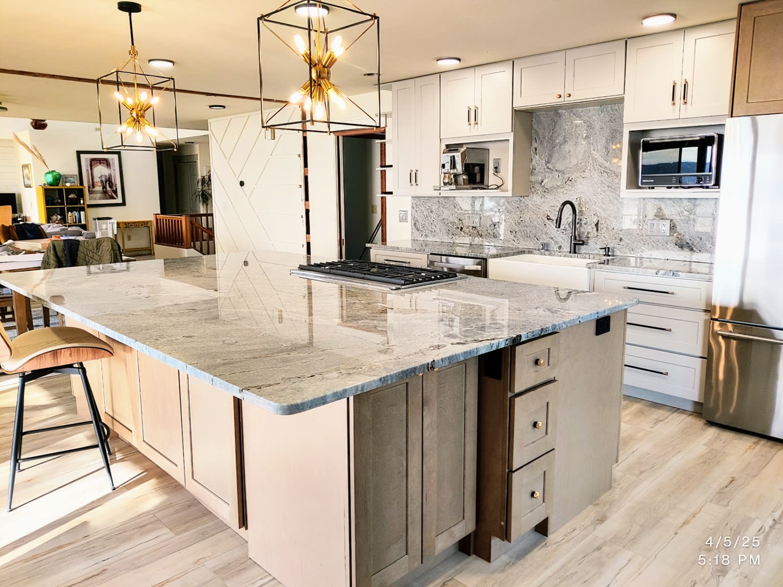 Contemporary kitchen with large maple island, granite counters and geometric pendant lighting